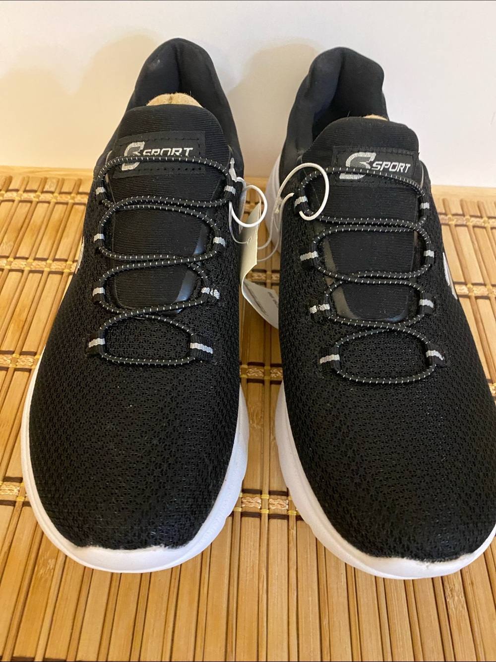 Sketcher’s “Rummie” Black Knit Slip-On Sneakers